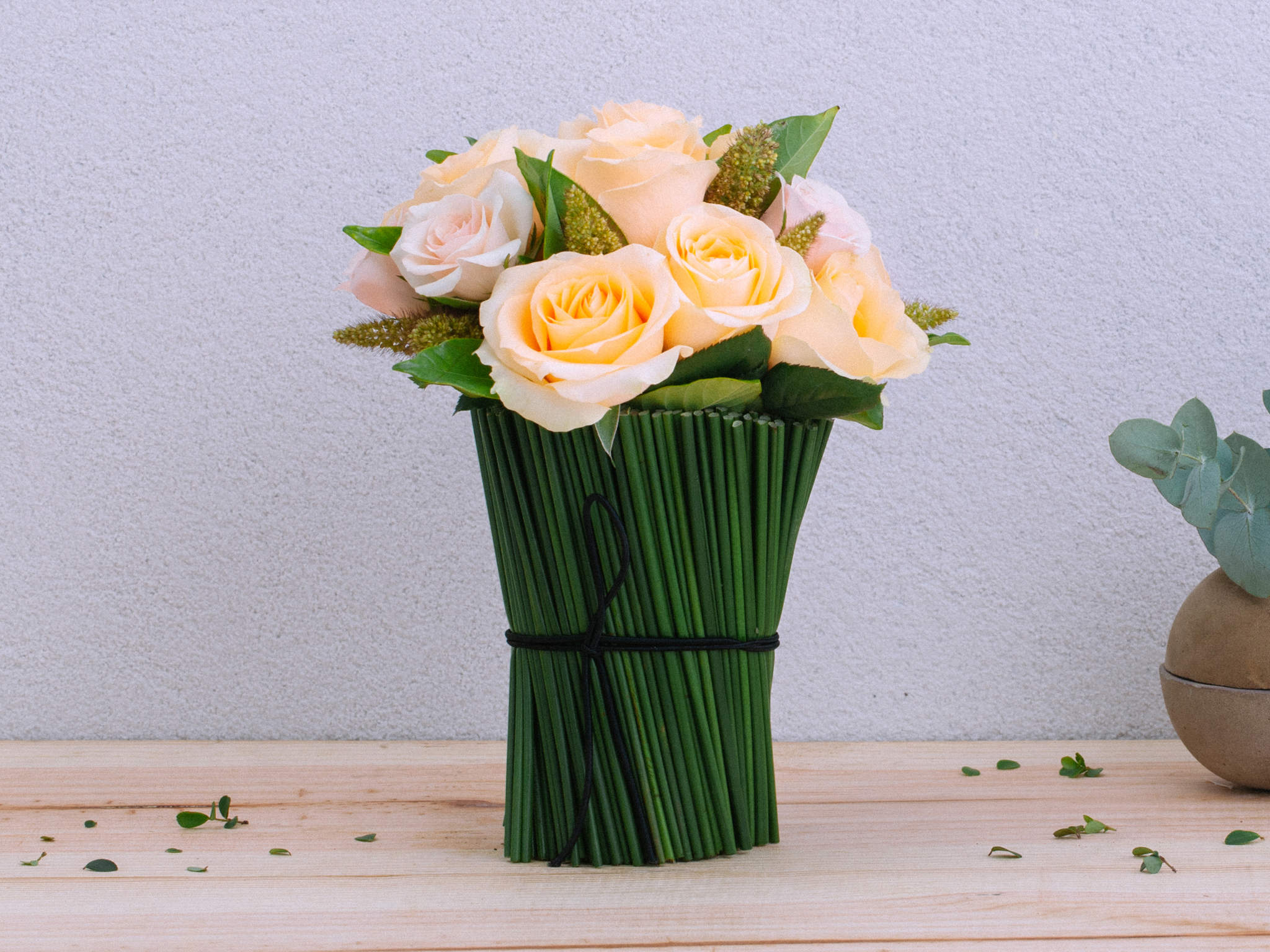 Arranjo de Rosas Salmão em Vaso de Vidro Revestido com Junco